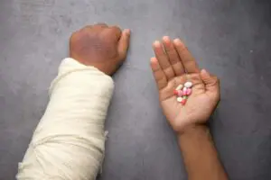  image of injured arm and hand holding medication representing personal injury statute of limitations in louisiana