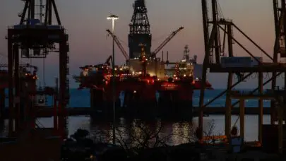 An offshore oil rig illuminated in the night. Oil rigs provide the perfect setting for chemical exposure for oilfield workers.