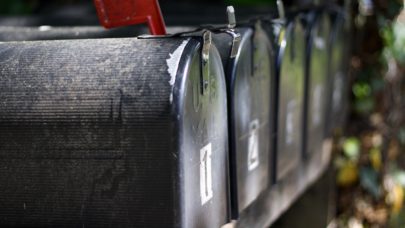 Row of mail boxes, one of which has a subpoena in it