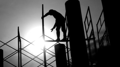 silhouette of a construction employee working in the hot sun