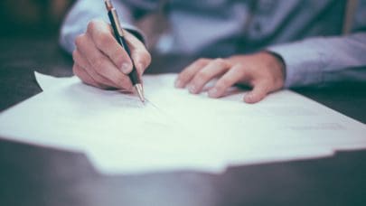 a lawyer signing paperwork